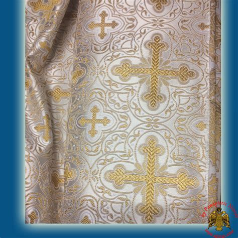 In the background a wall above which trees emerge, enclosed on either side by braid bands. . Orthodox liturgical fabric